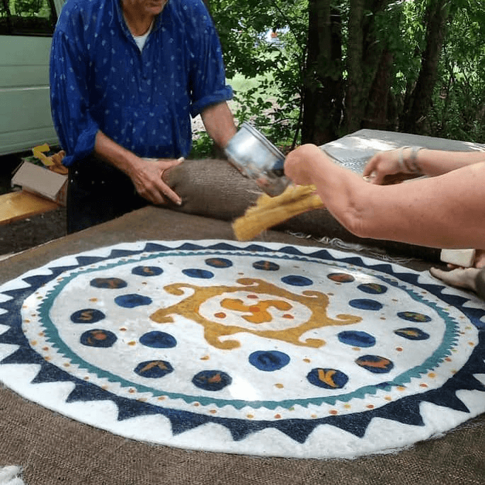 István Vidák is teaching us how to make felted rugs in its ancient ways. A friend is pouring hot water on them.